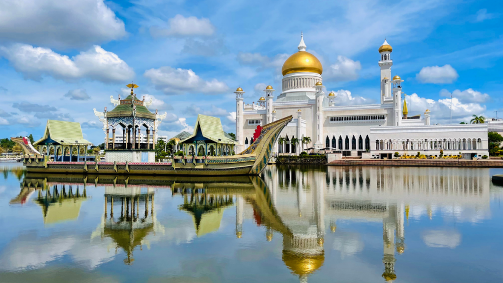 ブルネイの象徴的なオールドモスク(スルターン・オマール・アリ・サイフディーン・モスク)、ラグーンに映る姿と伝統的な船、夜のライトアップの写真スポット